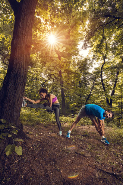 istock Young athletic couple exercising together in the park. 665789274