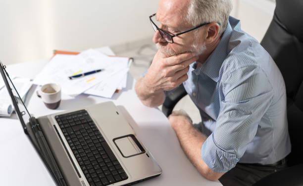 istock Pensive senior businessman with hand on chin 665789678