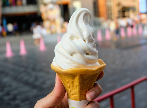 istock Ice cream cone held up in the city 665794496