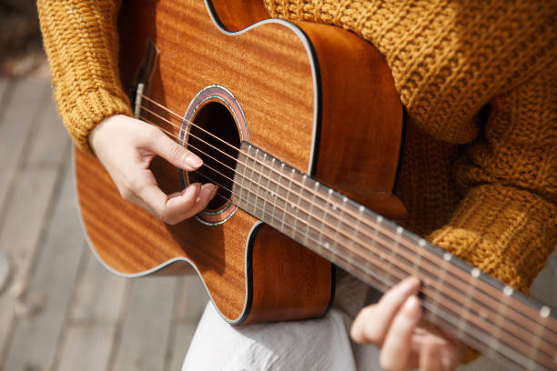 istock Young woman playing guitar 665795514