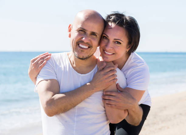 istock couple holding each other on the beach 665801828