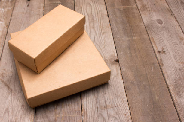 istock cardboard box on wooden background 665806624