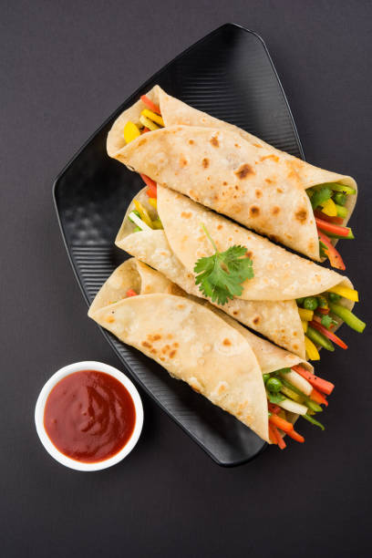 istock Indian popular street food called veg franky made using vegetables wrapped inside paratha/chapati/roti with tomato ketchup 665807568