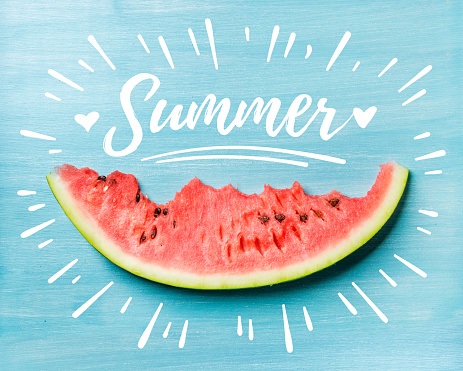 Summer concept. Slice of watermelon on turquoise blue background, top view. White lettering inscription