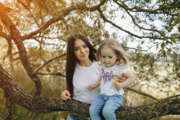 istock child near tree with mom 665813108