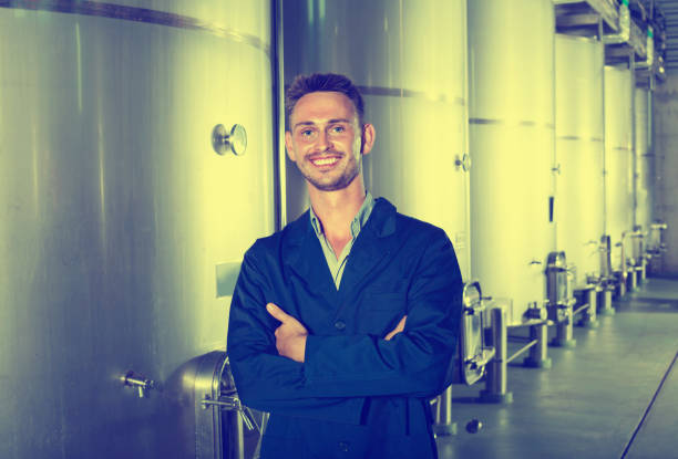 istock Portrait of man winery worker on wine factory in secondary fermentation section 665815528