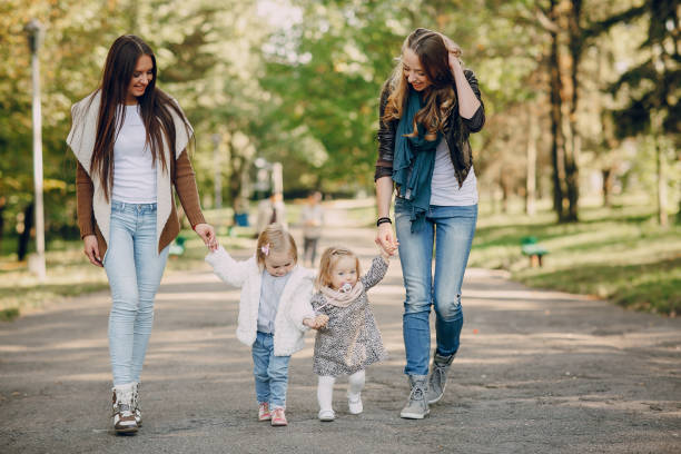istock young family walking in the park 665817332