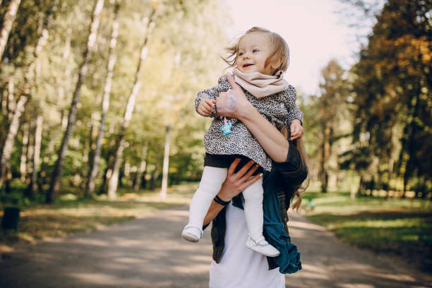 istock young family walking in the park 665830620