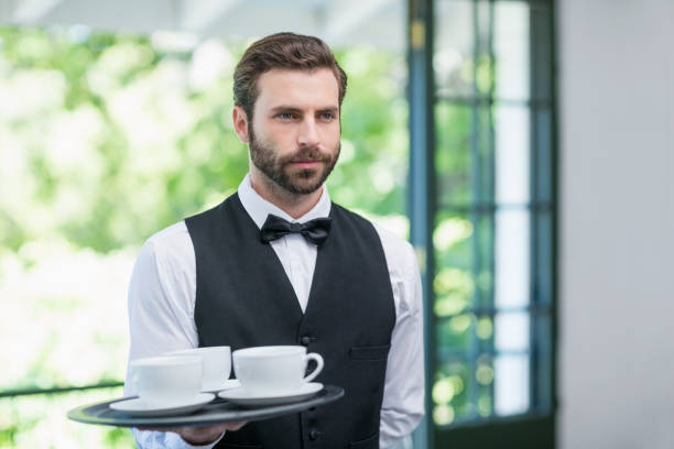 istock Male waiter holding tray with coffee cups 665831116