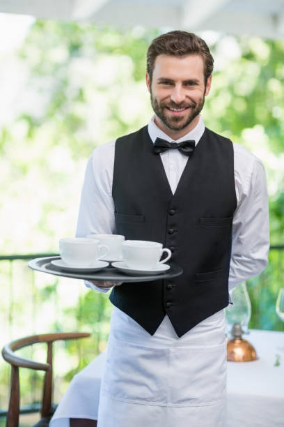 istock Male waiter holding tray with coffee cups 665831166