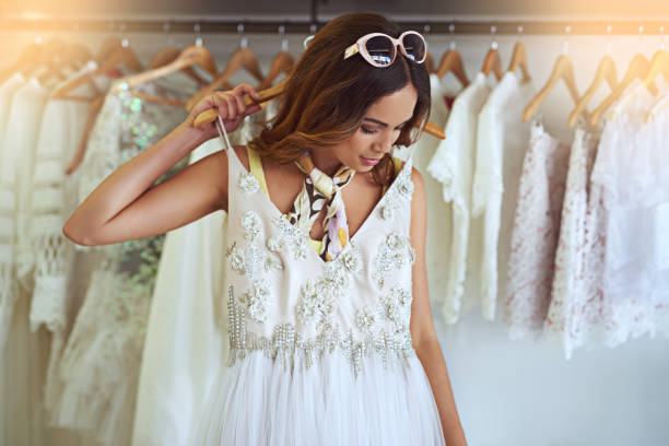 I think I found the one! Cropped shot of an attractive young woman searching for a wedding dress bridal shop photos stock pictures, royalty-free photos & images