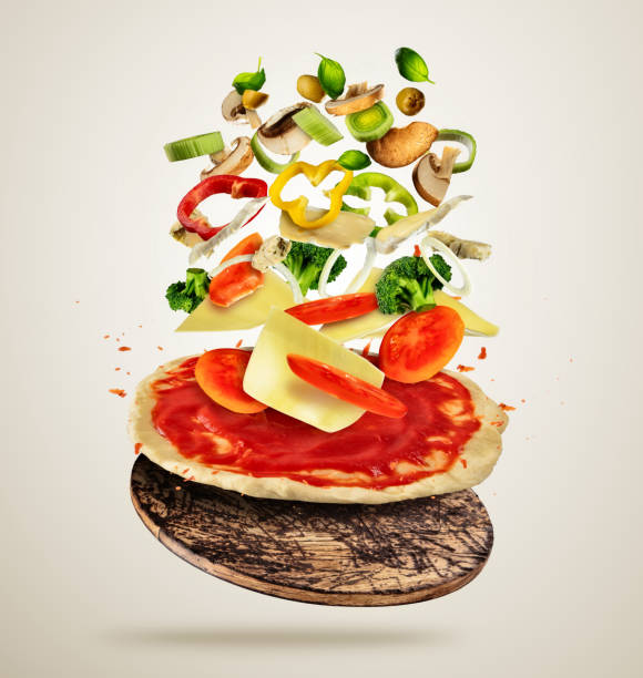 istock Flying ingredients with pizza dough, on creamy background 665848756