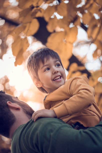 istock Father holding his son in park 665850612