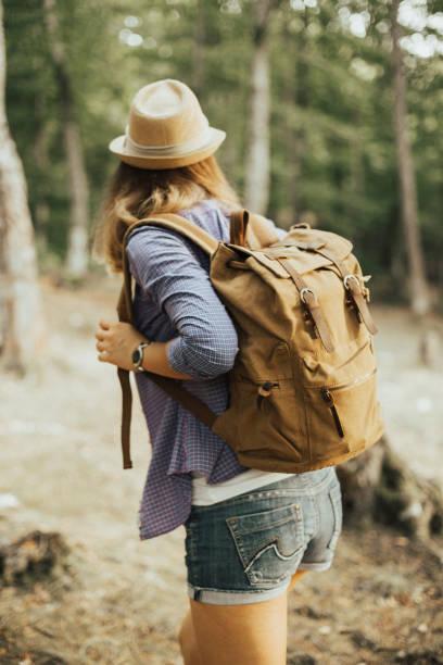 istock Rear view of woman hiker with backpack 665853306