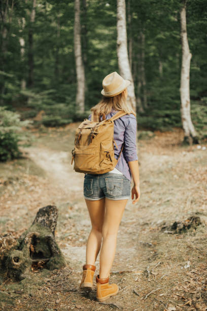 istock Woman in the woods with backpack 665856430