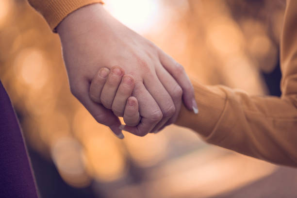 istock Mother and child holding hands in public park 665857210