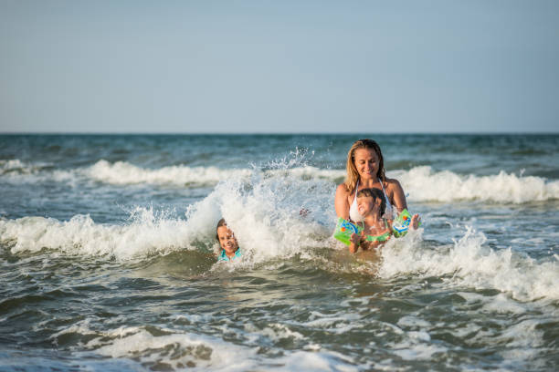 istock Family splashig in sea waves 665862190
