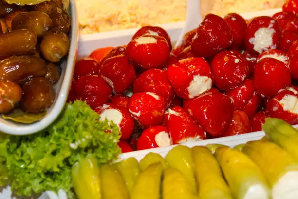 variation of healthy olives and pepperoni decorated with green salad and many colors