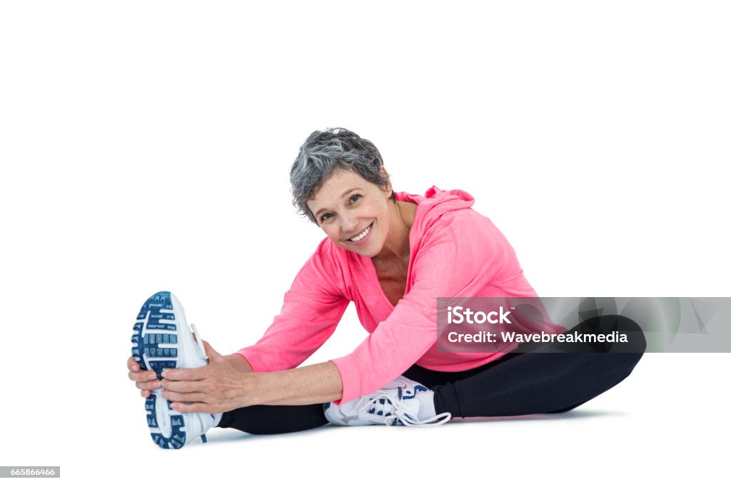 Portrait of mature woman exercising Portrait of mature woman exercising over white background Exercising Stock Photo