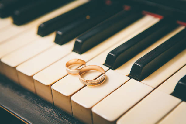 istock wedding rings on a piano 665866478