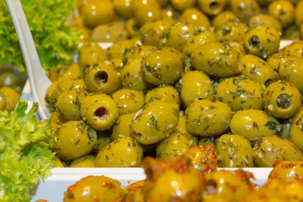 variation of healthy olives and pepperoni decorated with green salad and many colors