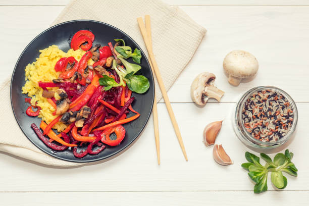 istock Rice and steamed vegetables on a black plate 665870108