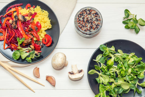istock Rice and steamed vegetables on a black plate 665870122