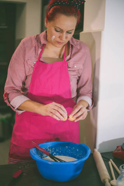 istock Woman whisking batter in kitchen 665871488