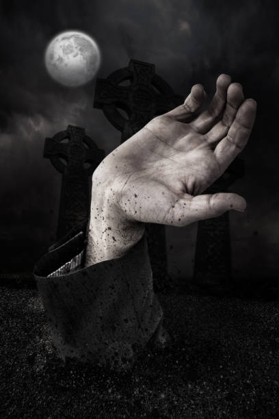 istock Zombie hand bursting from the grave 665878610