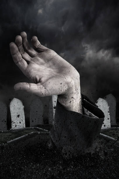 istock Zombie hand bursting from the grave 665878888