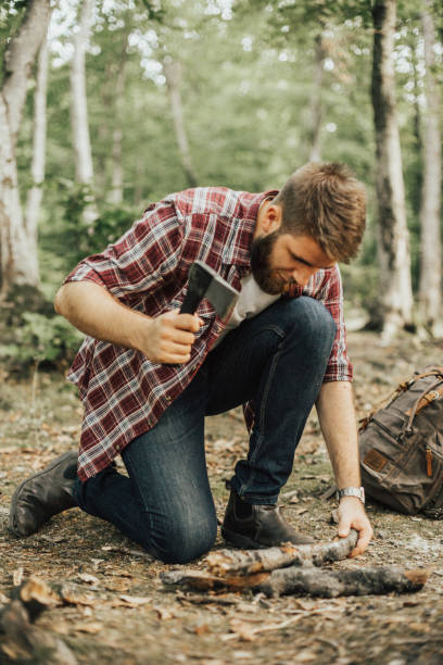 istock Hiker chopping wood for campfire 665879292