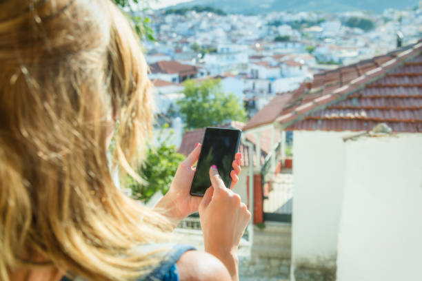 istock Cute girl using cellphone in front of a old house. 665879388