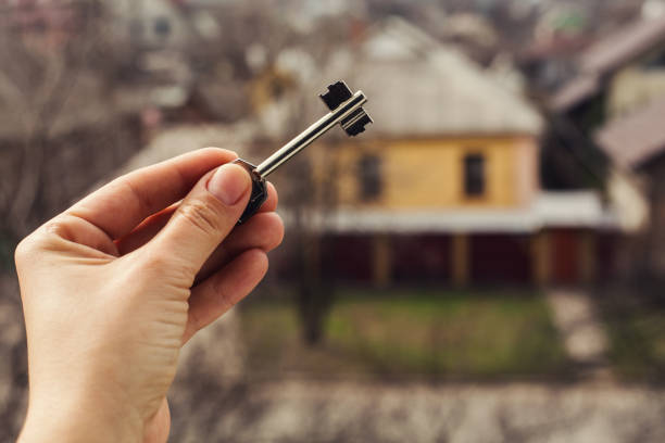 istock closeup hand with key in house background. 665885050