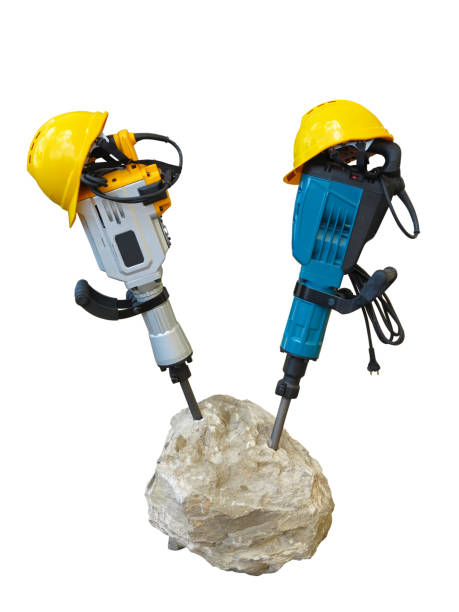 istock construction concept - jackhammer in concrete and yellow helmet isolated 665892942