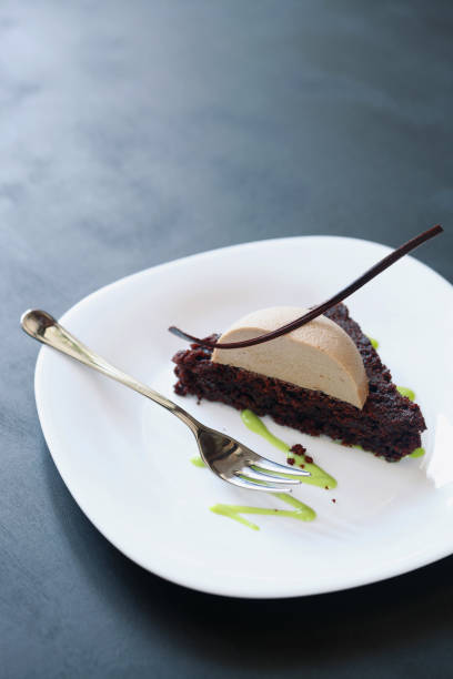 istock Dark chocolate brownie with praline mousse and pistachio cream 665893664