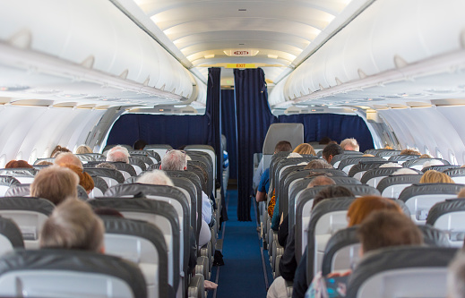 Commercial aircraft cabin with passengers