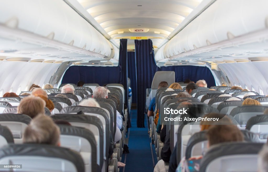 Commercial aircraft cabin with passengers Airplane Stock Photo