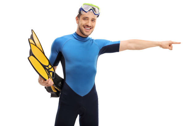 istock Guy in a wetsuit with snorkeling equipment pointing right 665897584