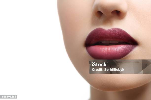 Close Up Shot Of Plump Sexy Female Lips Covered With Lipstick Stock Photo - Download Image Now