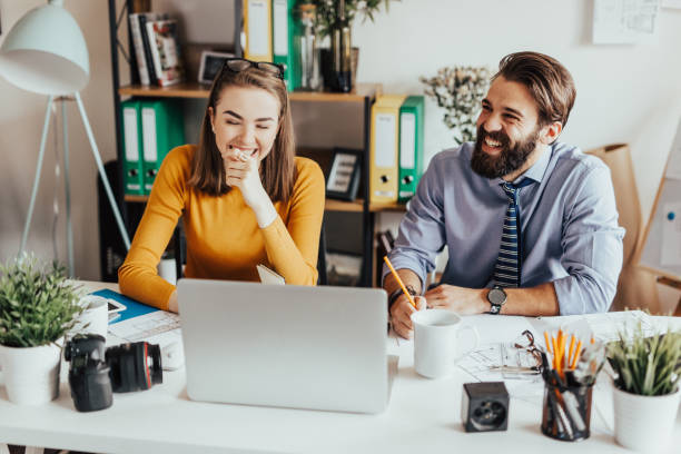 istock Two young smiling colleagues working together 665900602