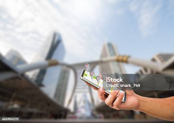 Hand Holding Mobile Phone With Navigation Symbol Stock Photo - Download Image Now - Address Book, Assistant, Backgrounds