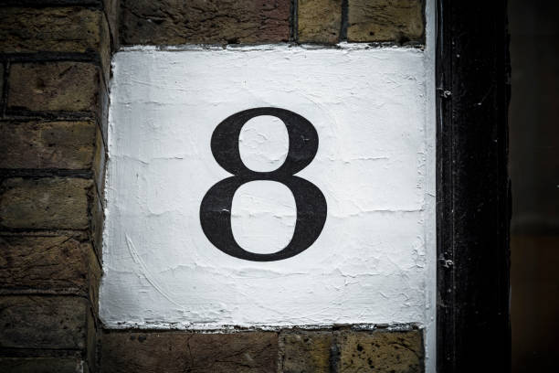 istock Number eight hand painted on plaster background 665906358