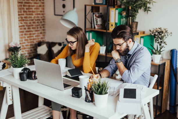 istock Two young businessman working together on a project 665907620