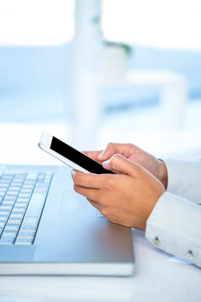 istock Cropped image of woman using smartphone 665907806
