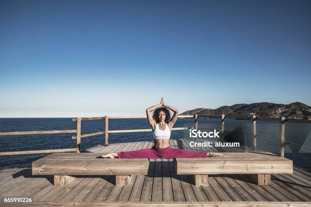 Woman Doing Exercises Outdoors Stock Photo - Download Image Now - Doing the Splits, 20-29 Years, Active Lifestyle