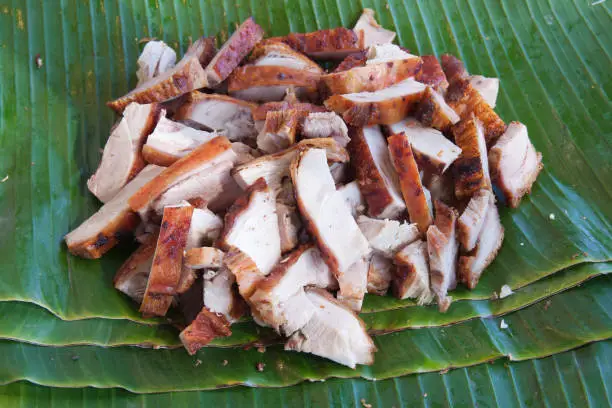 Photo of Background of roasted pork on banana leaf