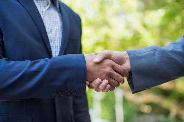 istock Businessmen shaking hands with each other 665910858