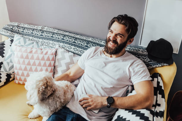 Handsome man in white t-shirt sitting in sofa