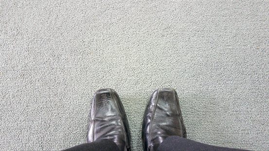 business man on the carpet floor with copyspace, Black leather shoes on carpet background