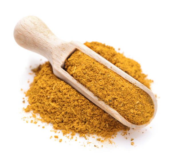 Curry spice in a scoop for spices stock photo